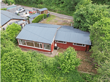 Two bedroom chalet bungalow enjoying a tranquil setting and requiring full refurbishment.
